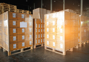 Stack of shipment boxes on wooden pallets at interior warehouse storage. Cargo export. Warehouse industry logisics and transport.