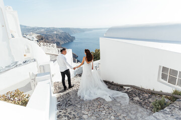 Wedding on Santorini island in Greece, beautiful couple, bride in a white wedding dress. White...