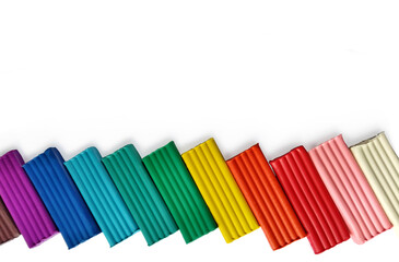 Background with mufti-colored Plasticine bars with place for text. school stationery for modeling
