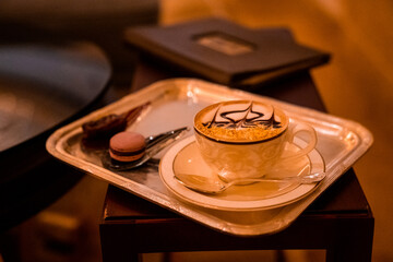 Cup of Golden Cappuccino in Abu Dhabi. Coffee with gold decoration. UAE. United Arab Emirates.