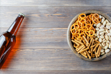 Beer and snacks on a brown wooden background. Menu for a pub or restaurant. Copy space.