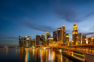 Fototapeta na wymiar Singapore 2019, iconic view from Singapore river to Marina Bay Sands and Central Business District. Blue hour reflection on the water during sunrise sunset
