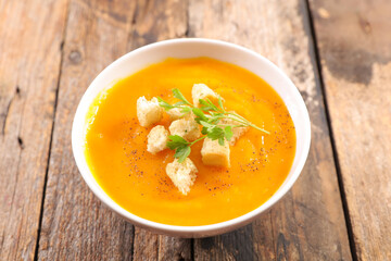 pumpkin soup with crouton on wood background
