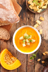 pumpkin soup with crouton on wood background