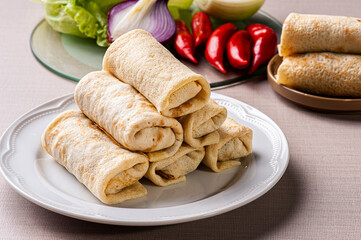 .Homemade pancakes stuffed on a white plate. Blini