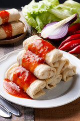 .Pancakes with meat, in tomato sauce and cheese.