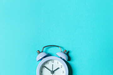 Simply minimal design ringing twin bell vintage classic alarm clock Isolated on blue pastel...