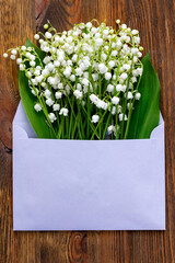 Bouquet of lilies of the valley in an envelope