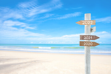 wooden sign on sand beach for outdoor advertising summer vacation concept, for your text.