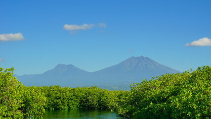 A view from Bali strait to Java island. Bali Strait is a stretch of water separating Java and Bali while connecting the Indian Ocean and the Bali Sea. 