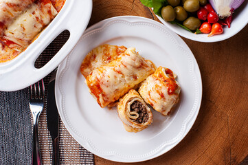 .Pancakes with meat, in tomato sauce and cheese. View from the top.