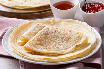 Traditional Russian Crepes Blini. Homemade thin pancakes. .Accompanied by jam and honey