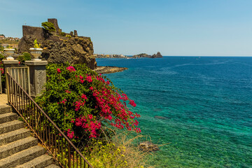 A view across the seafront in Acicastello, Sicily looking towards the Norman castle and the islets...
