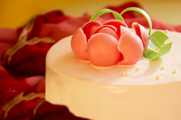 pink cake closeup with decore of rose on the table. Sidewiew.-Image