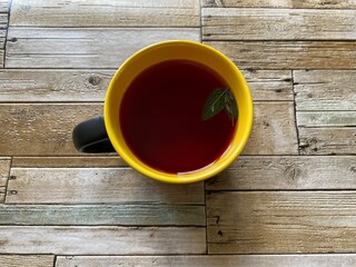 cup of tea and crochet on a wooden background