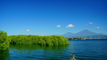 A view from Bali strait to Java island. Bali Strait is a stretch of water separating Java and Bali while connecting the Indian Ocean and the Bali Sea. 