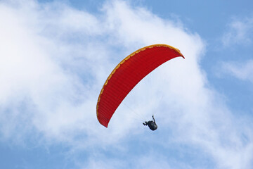 Paraglider flying wing in a blue sky	
