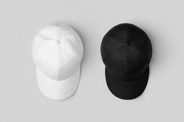 White and black baseball caps mockup, side by side.