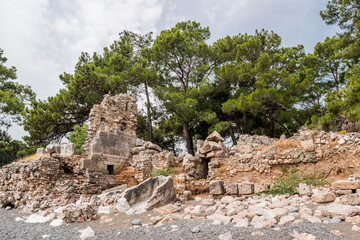 Fototapeta na wymiar Ancient cemetery. Ruins of Phaselis city in North harbour. Famous architectural landmark. Turkey.