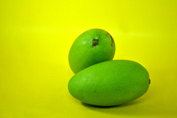 green mango with yellow background
