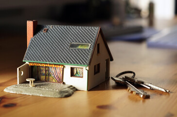 A close up shot of a house and keys - real estate business concept