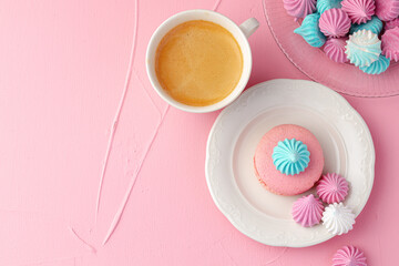 Cup of coffee with colorful cookies close up