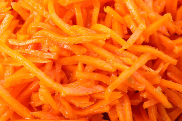 Tasty carrot salad on whole background, close up