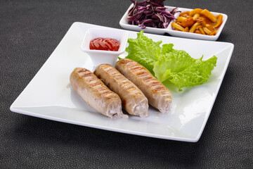 Grilled sausages served mushrooms and cabbage
