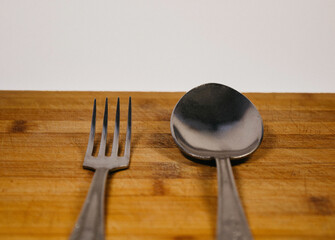 fork and spoon on wooden table