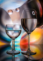 Beautiful wine glasses on colorful background
