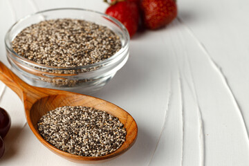 Bowl with raw chia seeds close up