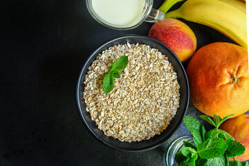 oatmeal in a cup and fruits Menu concept serving size. food background top view copy space for text organic healthy eating raw