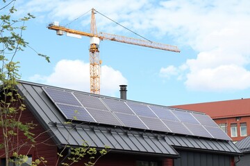 Solar panels producing solar energy on the roof of a modern detached house in a new neighbourhood....