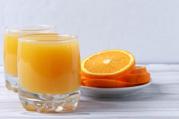 fresh rich of vitamin С citruses and 100% natural orange juice in glasses