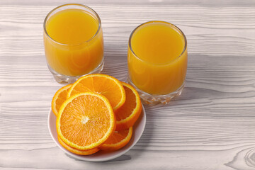 fresh rich of vitamin С citruses and 100% natural orange juice in glasses