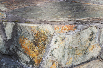 Natural stone in orange and gray in natural light. Textures and backgrounds of natural origin.