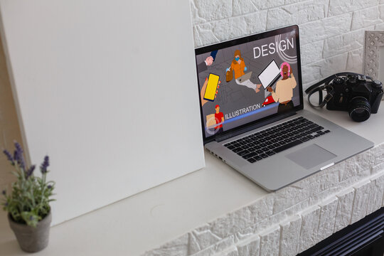 Closeup shot of laptop on desk. Responsive design web page on their screen. Modern devices on desk at office.