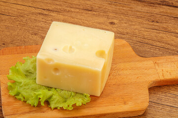Emmental cheese over wooden board