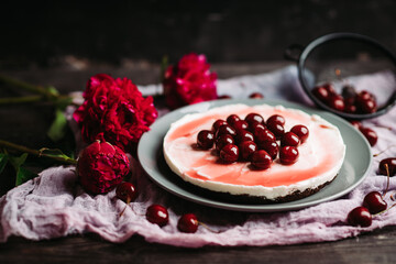 Fresh cheesecake with cherries on the rustic background. Selective focus. Shallow depth of field.