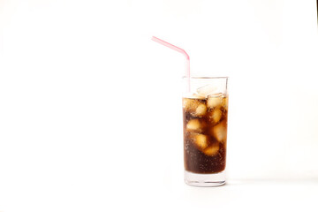 Refreshing glass of cool cola with ice and straw on a white background