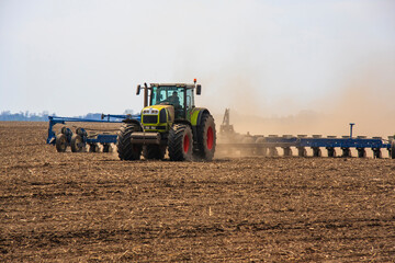 Farmer in tractor preparing farmland with seedbed for the next year