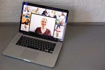 Business Person Videoconferencing With Colleagues On Laptop
