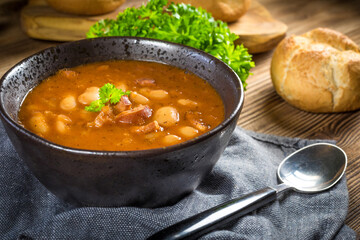 Beans with tomato sauce, bacon and sausage.