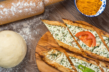 Traditional turkish baked dish pide. Turkish pizza pide, Middle eastern appetizers. Turkish cuisine. Top view. Pide with cheese filling