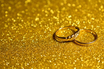 Gold wedding rings on a Golden background