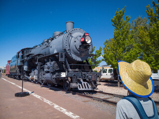 Fototapeta na wymiar Williams, Arizona USA: Steam locomotive train in the city on Historic Route 66, south terminus of Grand Canyon Railway.