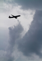 Fototapeta na wymiar Airliner and Threatening Clouds