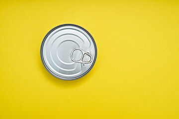 Tin can on a yellow background, top view