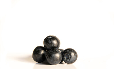 Composition of blueberries on a white background with copy space. Healthy food concept.