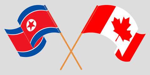 Crossed and waving flags of North Korea and Canada